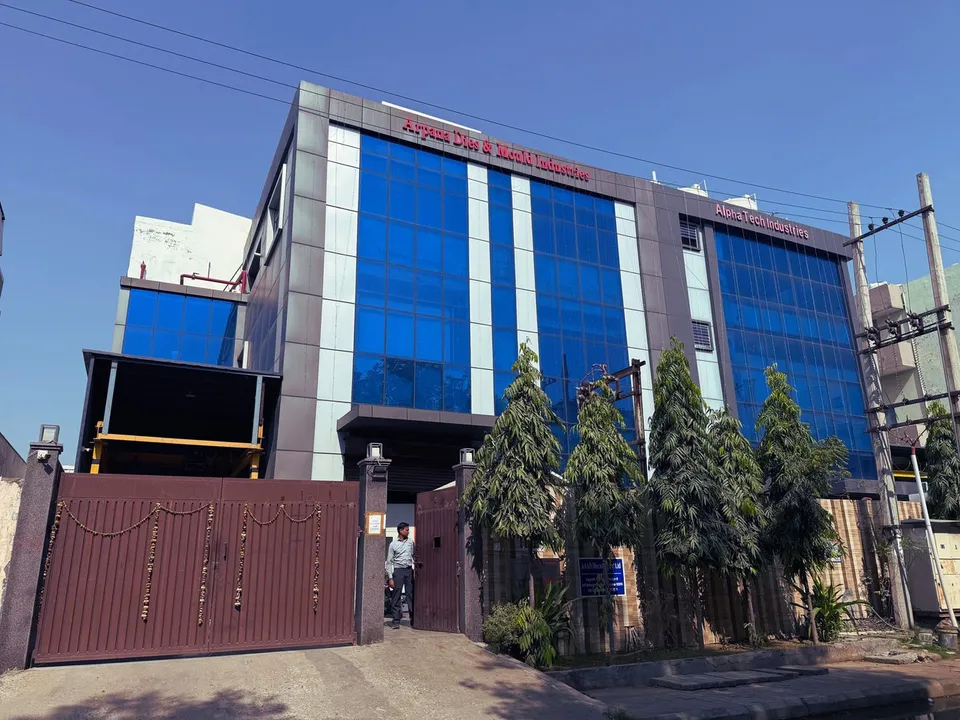 Arpana Dies & Mould Industries building with a blue glass facade