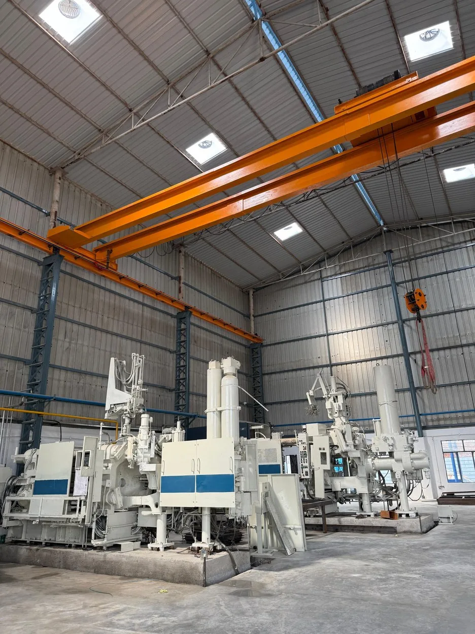 Toshiba die-casting machines under an overhead crane on the shop floor